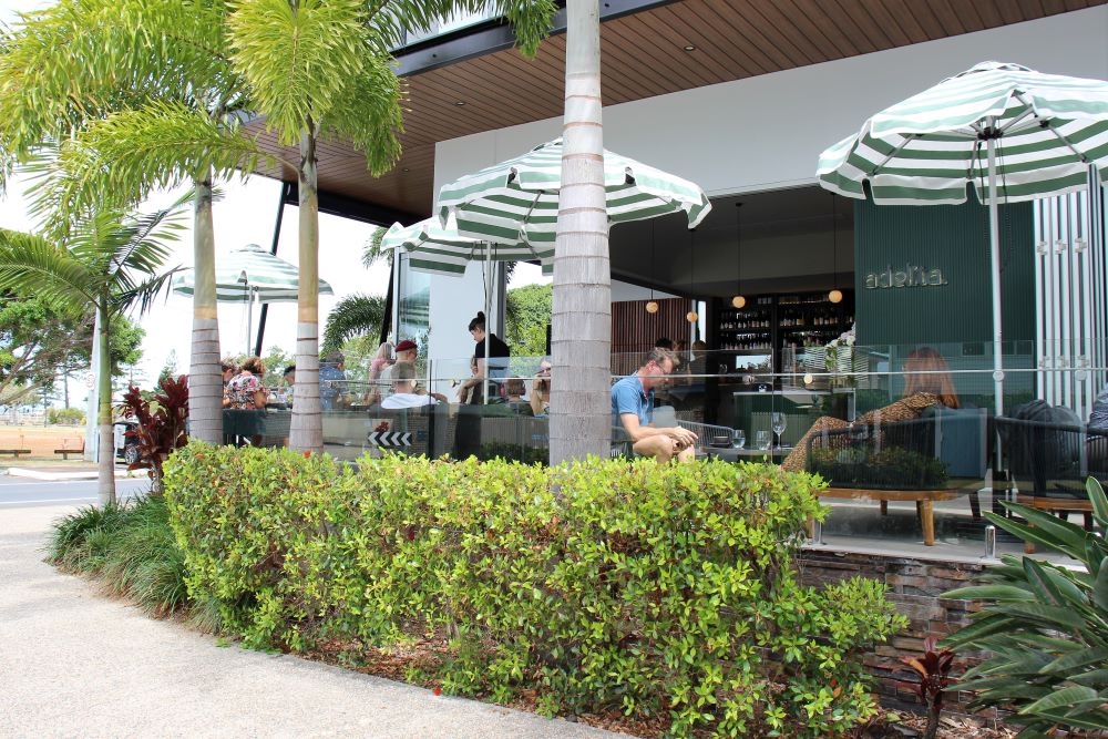 People sitting at tables outside Adelita Wine Bar 