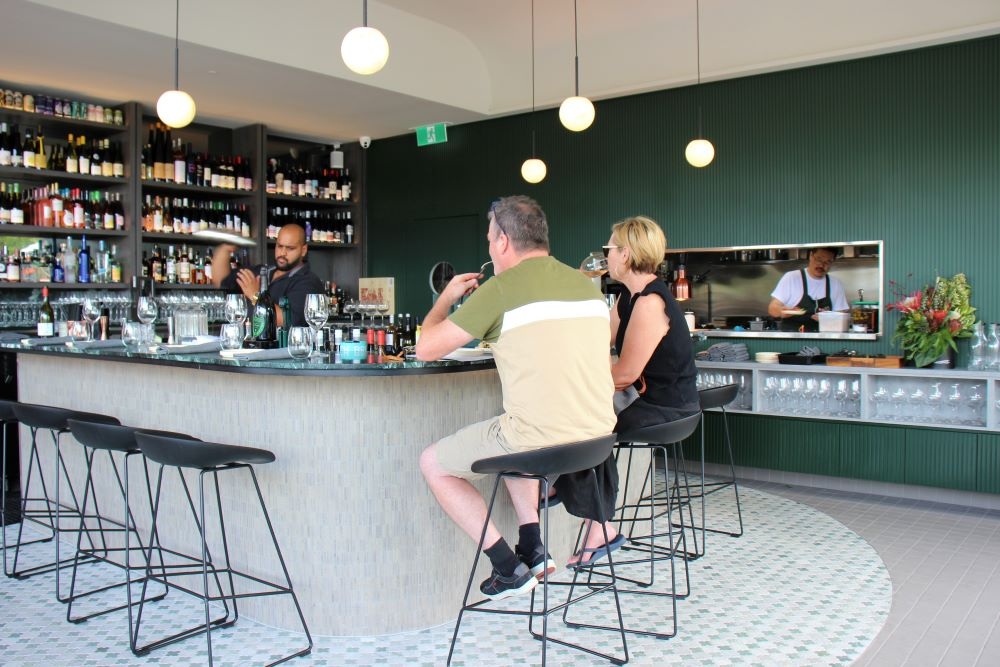 People seated at bar at Adelita Wine Bar 