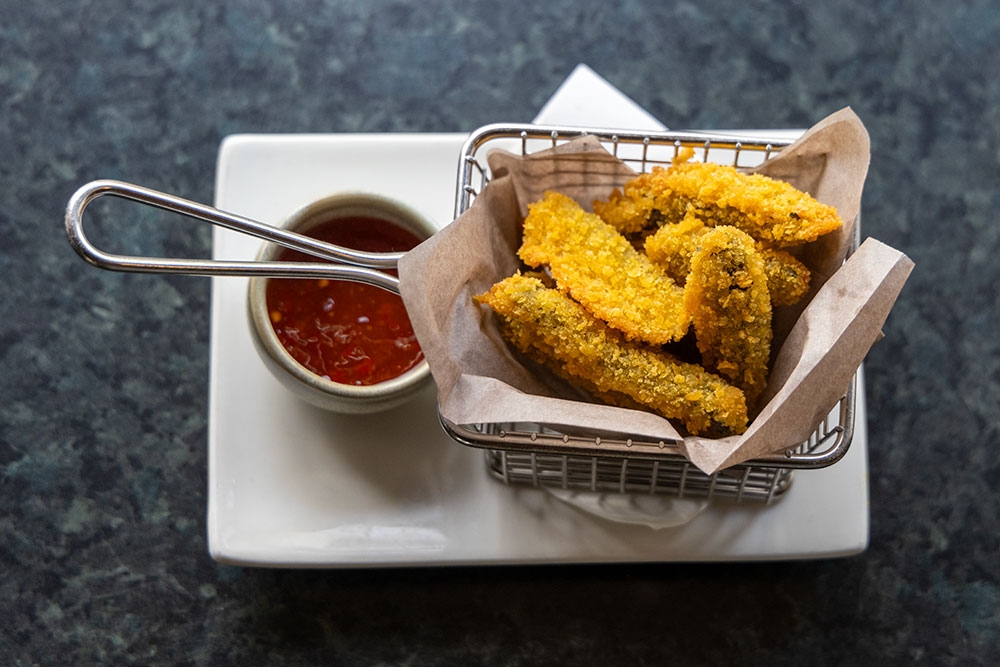 Fried food in a basket on a plate with sauce at The Alliance Hotel Spring Hill