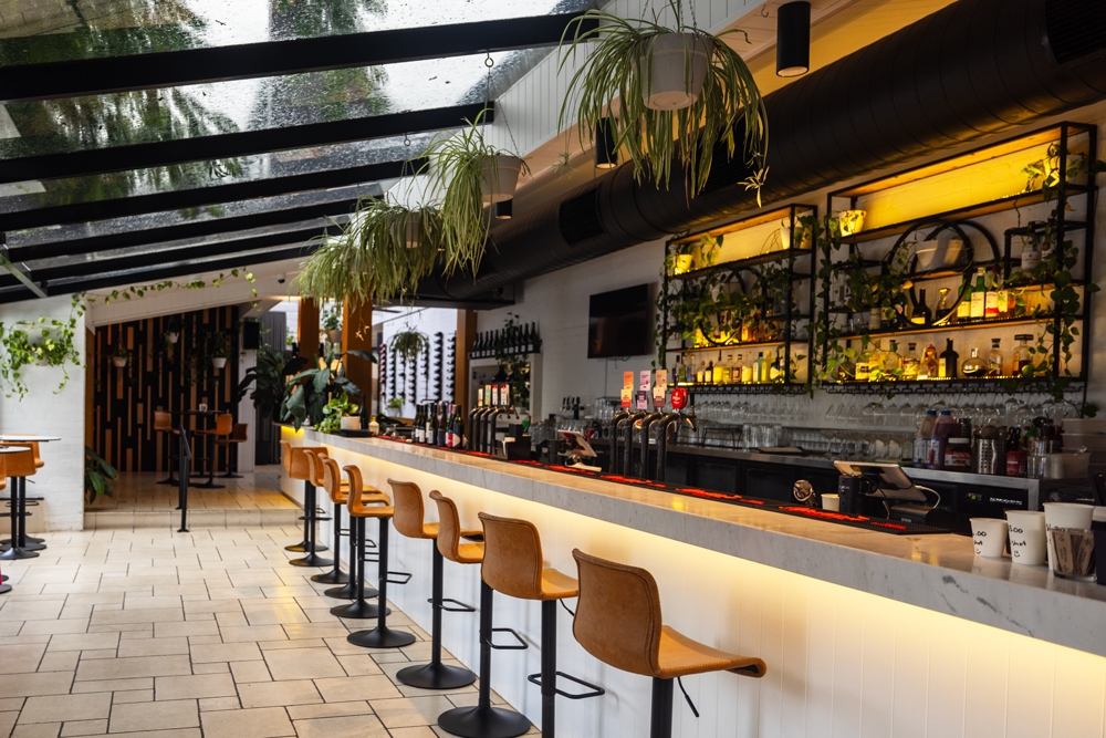 Interior bar with tan leather stools Aroma @ Ascot