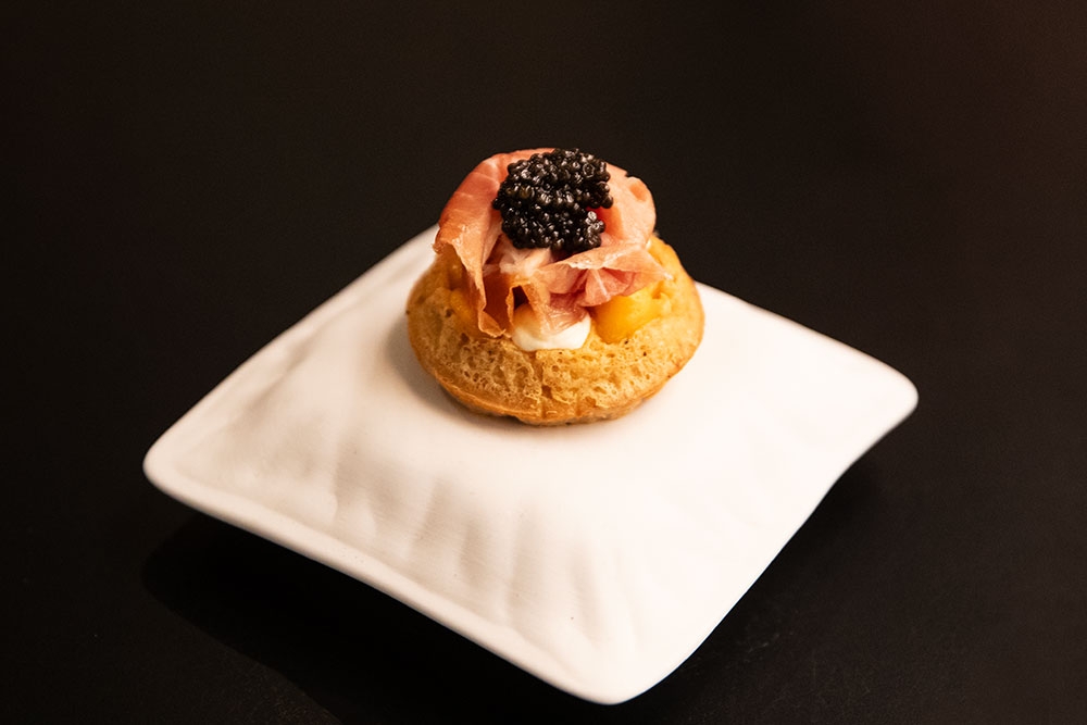 Cecino Waffle with caviar on white plate, Attimi Restaurant