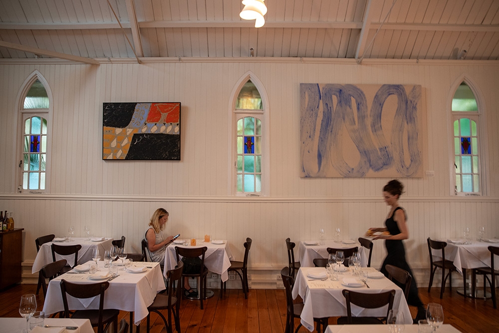 Dining tables against wall at  August restaurant West End