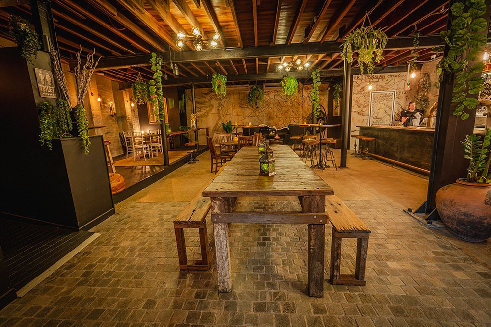 Table and chairs inside Bar Mesopotamia Milton