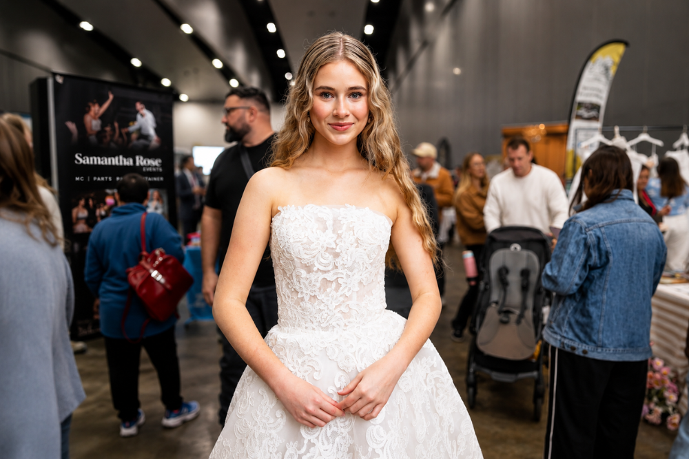 Girl posing in a wedding dress at Brisbane's Annual Wedding Expo