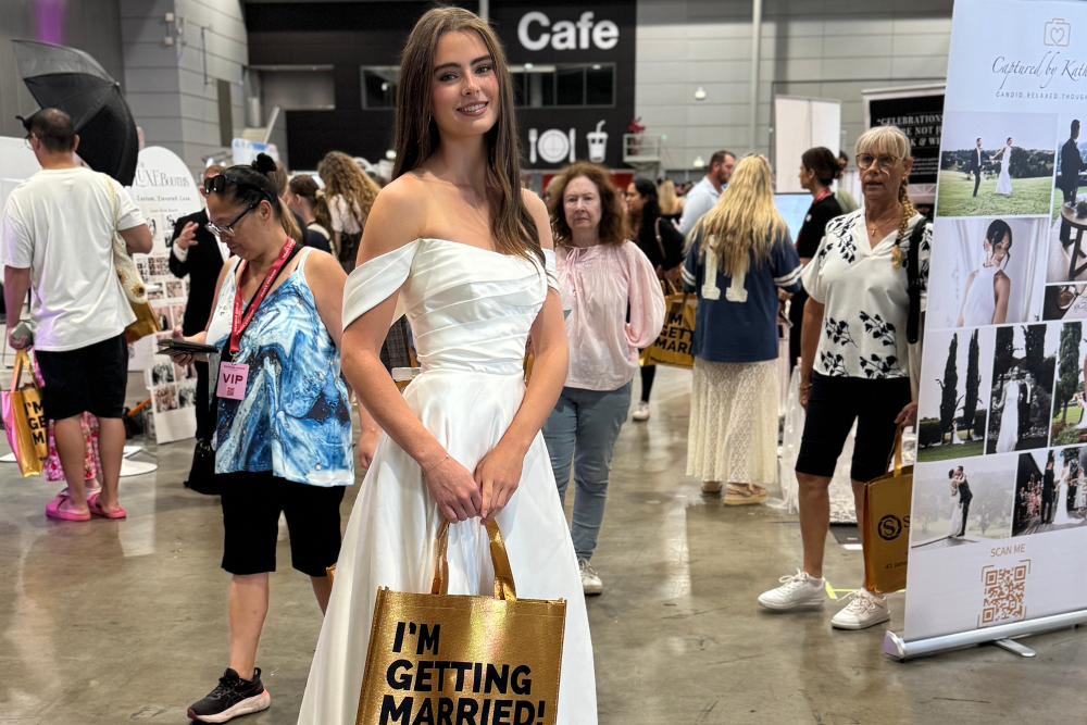 Girl posing in a wedding dress at Brisbane's Annual Wedding Expo