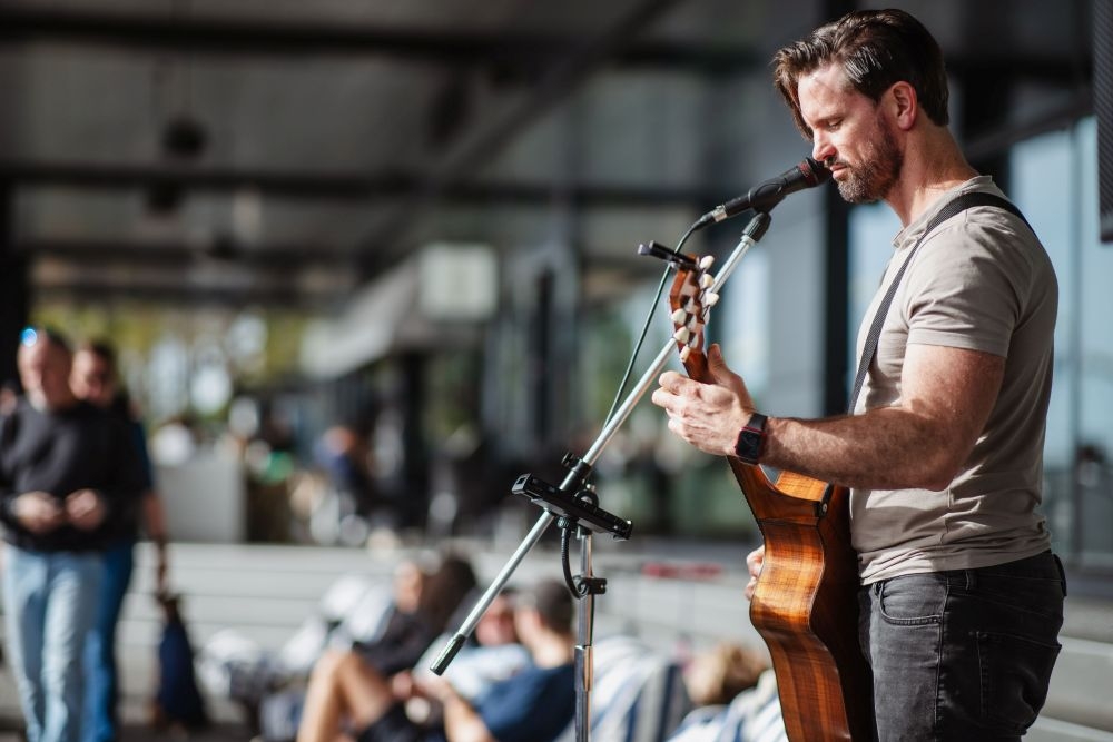 Man playing guitar at Farm Gate Market