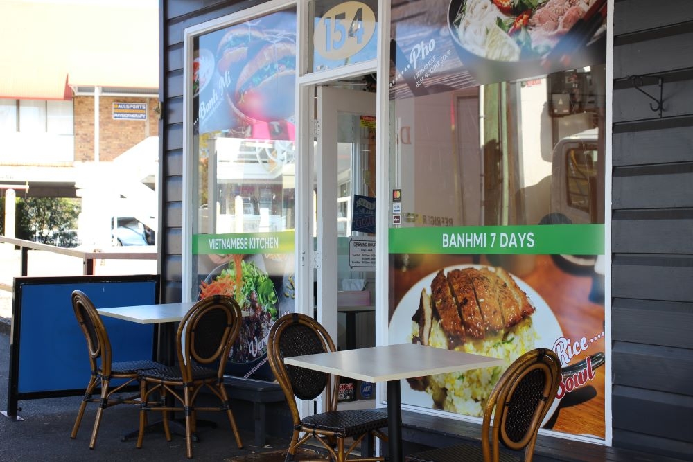 Entrance to BanhMi7Days, Red Hill with two tables and chairs outside on footpath