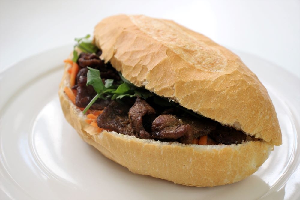 A meat-filled banh mi on a plate at the Banh Mi Factory, Newstead 