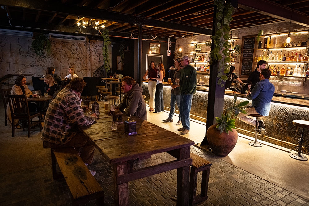 People standing and sitting inside Bar Mesopotamia Milton