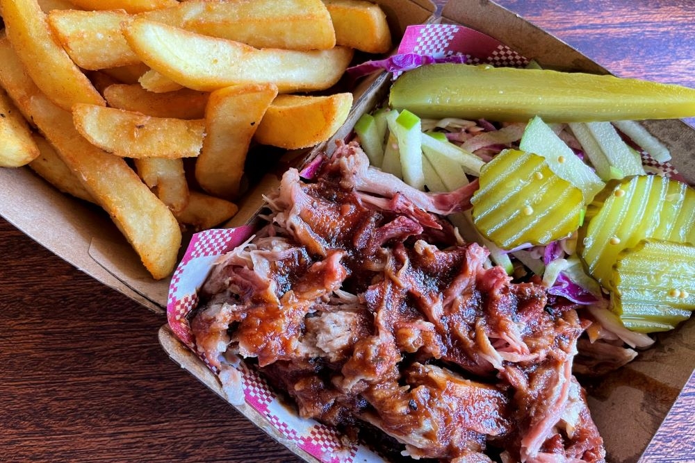 Meat, salad and fries in a cardboard box at Bare Knuckles BBQ, Salisbury