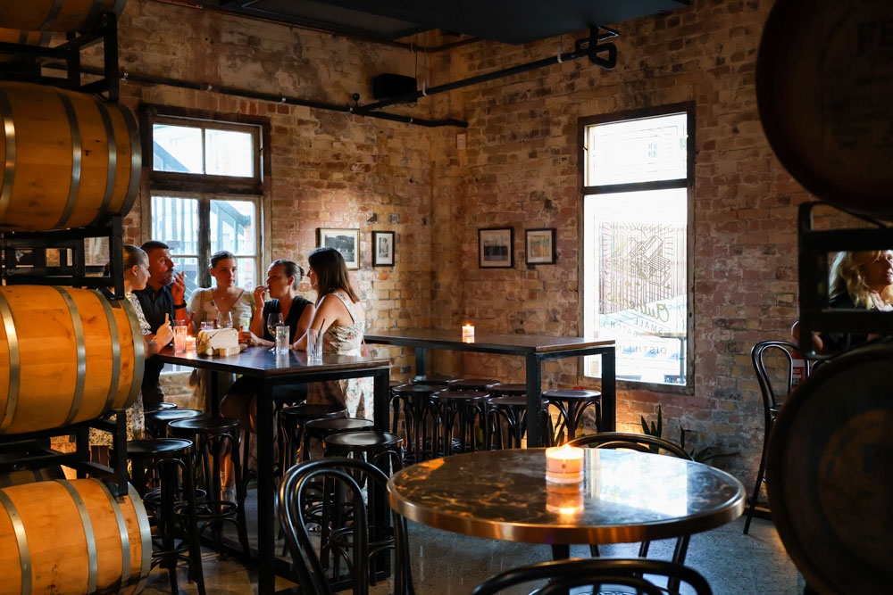 People seated inside Bavay Distillery 