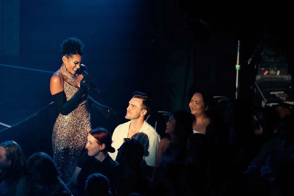 Performer talking to audience Blanc de Blanc Encore