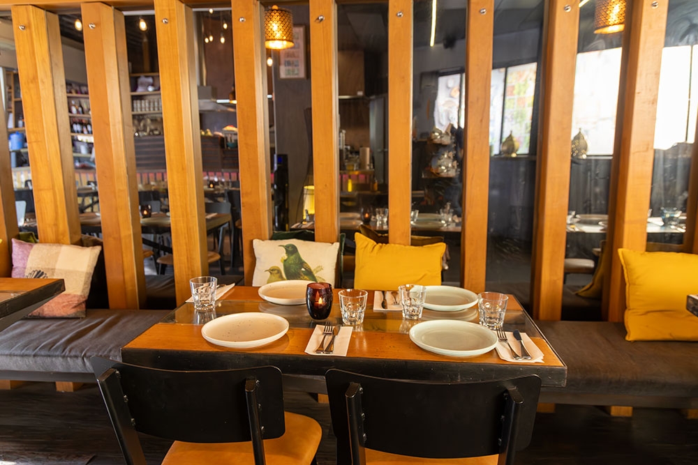 Table and chairs inside Boo's Kitchen, Woolloongabba