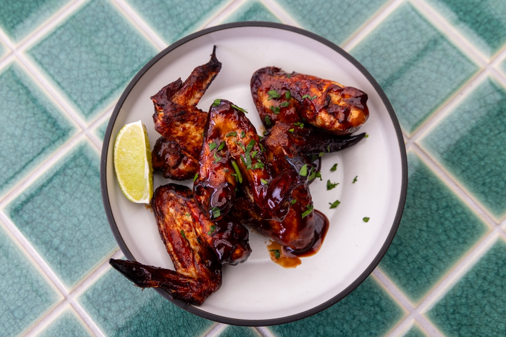 Plate of chicken wings with lemon wedge at Brighton Hotel
