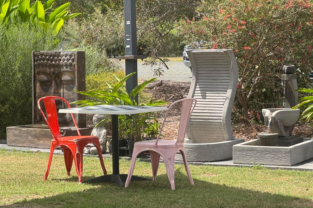 Tables and chairs on lawn at Bush House Home & Garden Market