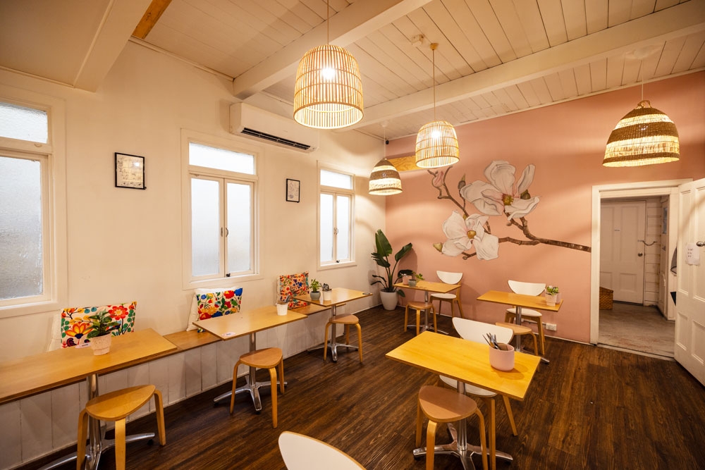 Dining room with tables, and a painting wall with flowers, C'sis Espresso Bowen Hills 
