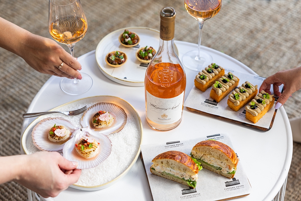 Plates of seafood with bottle of Rosé 