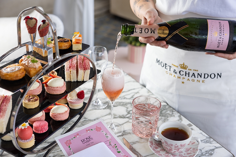 Pouring bottle of Moët & Chandon Impérial Rosé with high tea selection