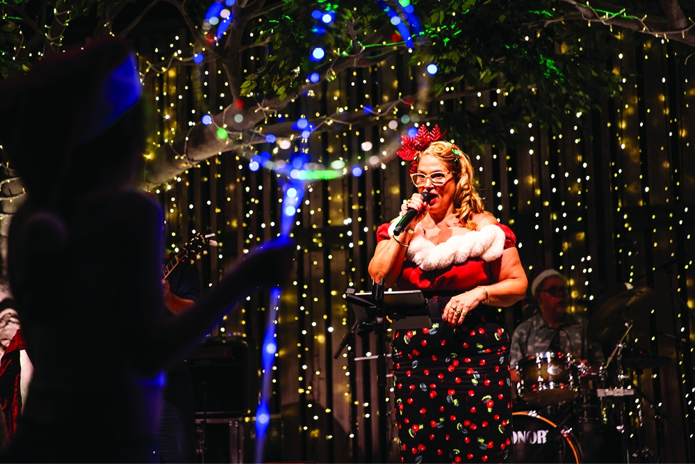 Performer singing on stage at Christmas at Nicholas St Precinct