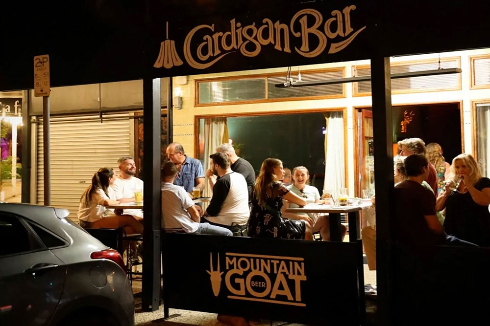 People seated outside Cardigan Bar Sandgate