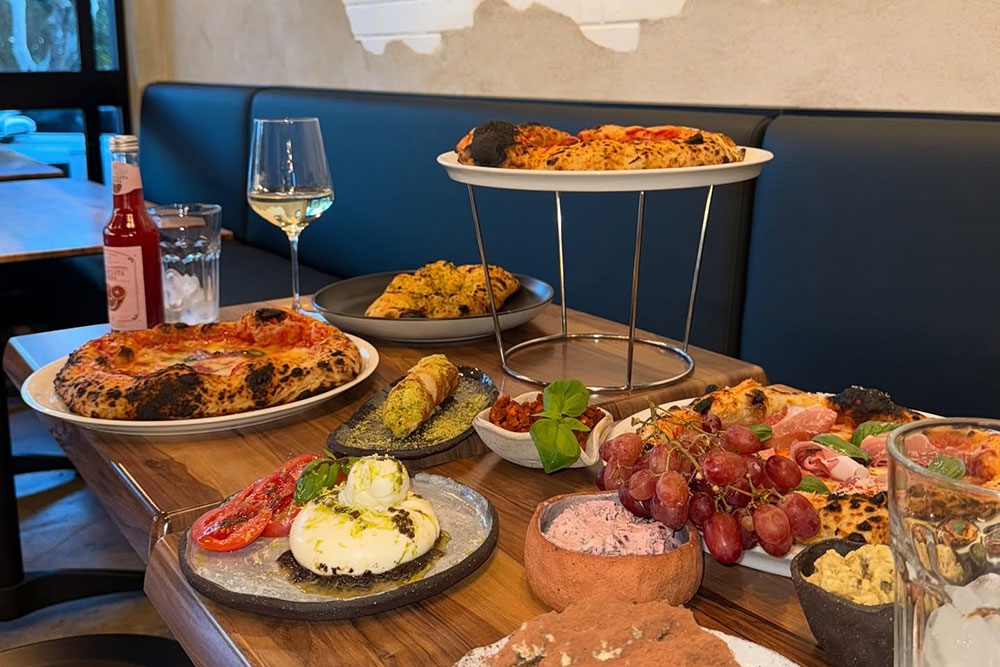 Dishes of food on table at Chef Jon Pizzeria and Bistro Kenmore