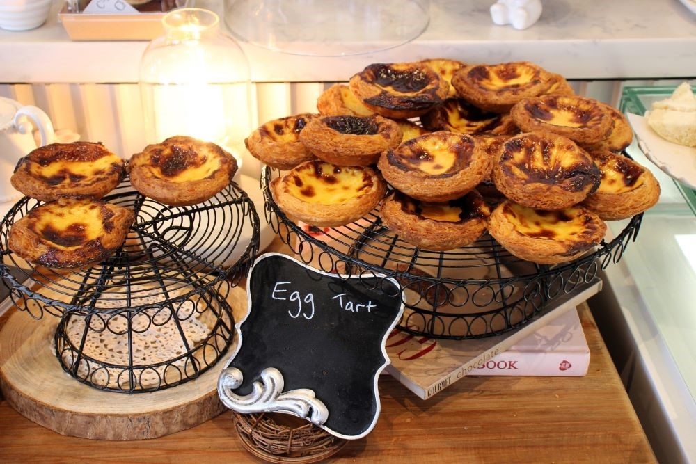 Two stands of egg tarts at Chouette Cake & Dessert, Underwood 