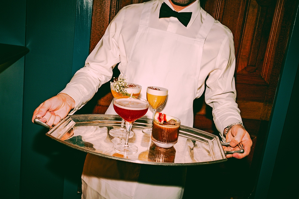 Waiter serving cocktails on tray at Club Felix Brisbane CBD