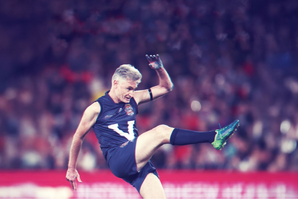 Dave Hughers kicking ball