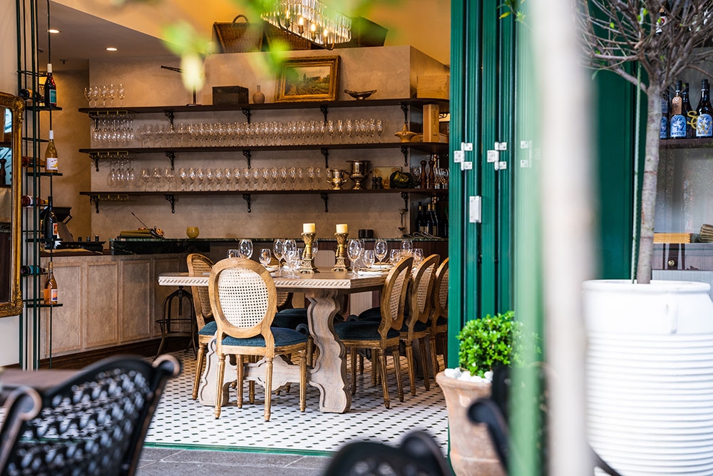 Looking into open doors through tables and chairs at South City Wine Bar Woolloongabba