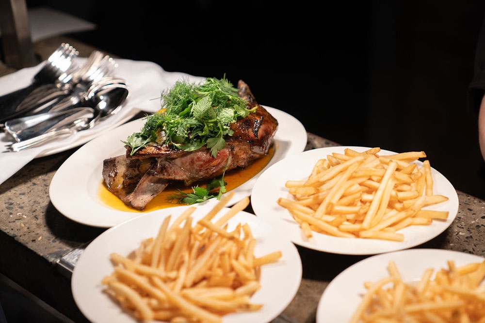 Plates of food on table at Never Enough Fortitude Valley