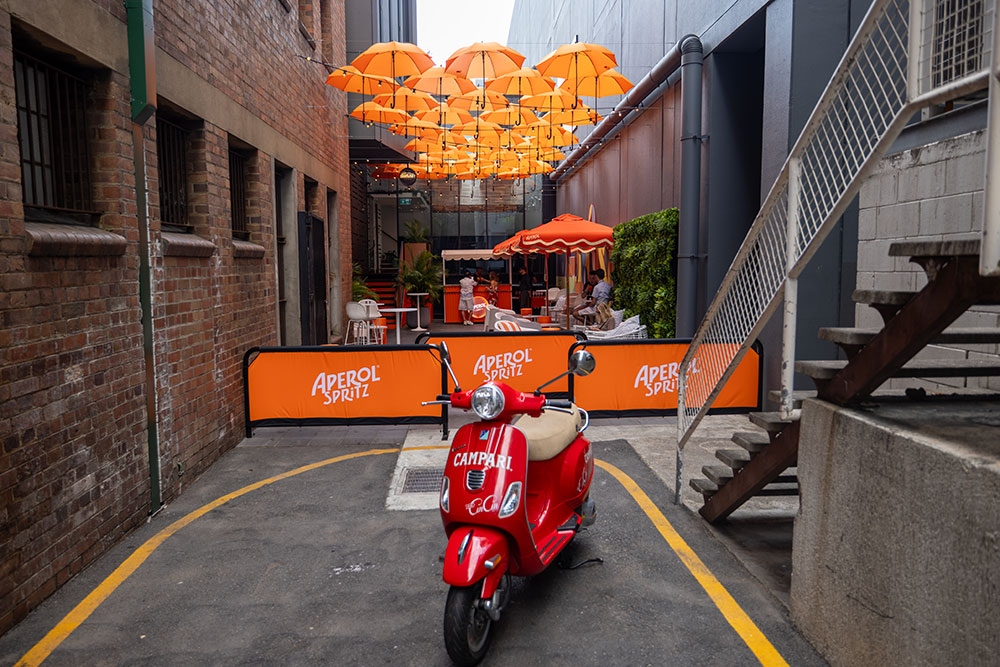 Orange Vespa parked at entry to Doughcraft Lane