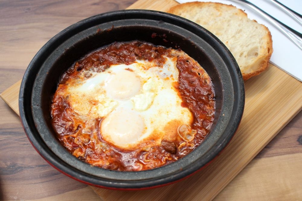 Free-range eggs baked in housemade chilli con carne served with toasted sourdough served at Dovetail Social, Highgate Hill 
