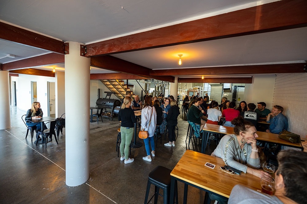 People standing and sitting inside Flat Lizard Brewing Stafford