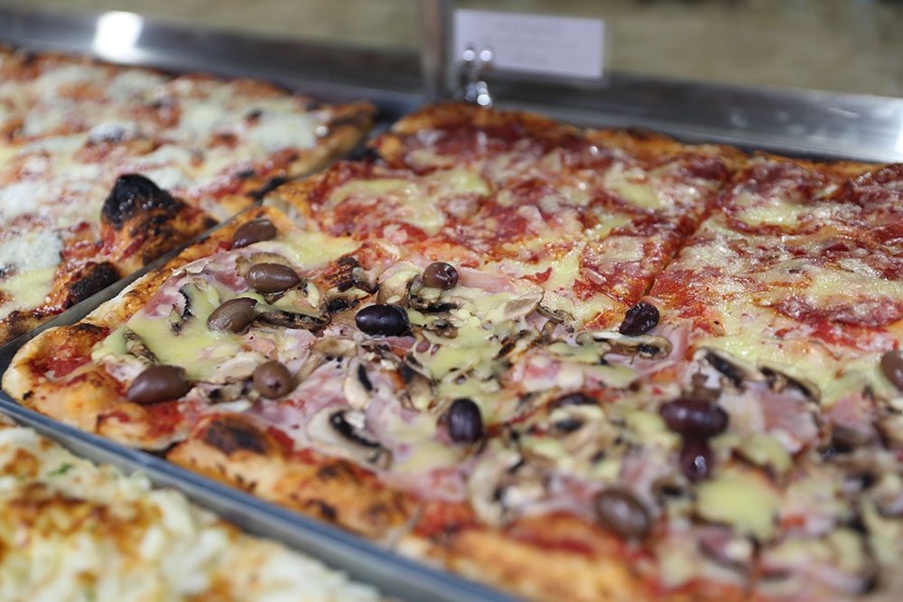 Pizzas on tray at Florentia Pizza Al Taglio Coorparoo