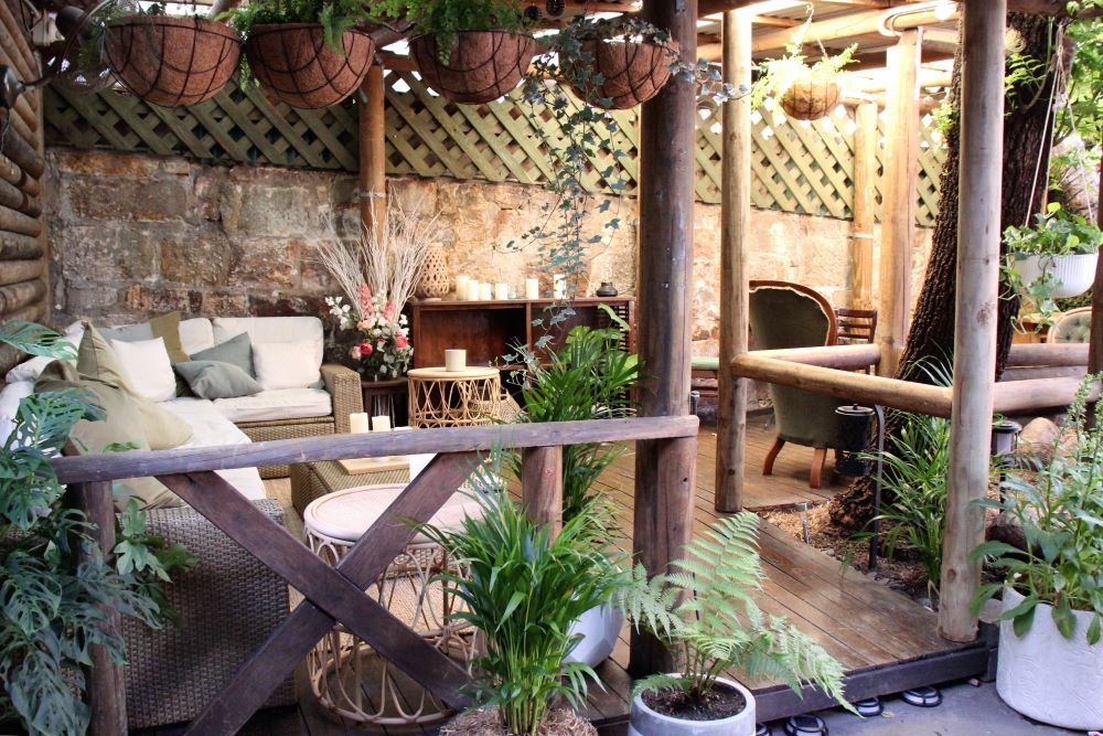 Tables and chairs inside courtyard at The Fourth Monkey Bar, West End