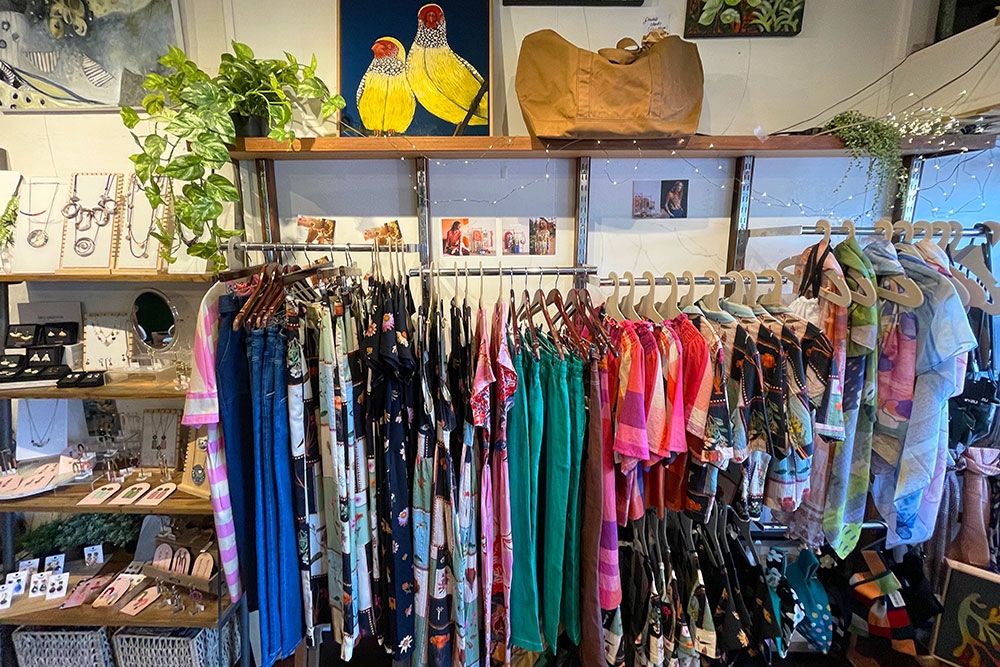 Racks of clothing and accessories for sale inside Green Tangerine, Paddington