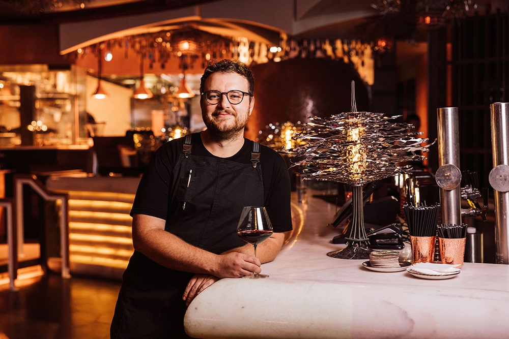 Staff member with glass red wine at Cloudland Garden Restaurant Fortitude Valley