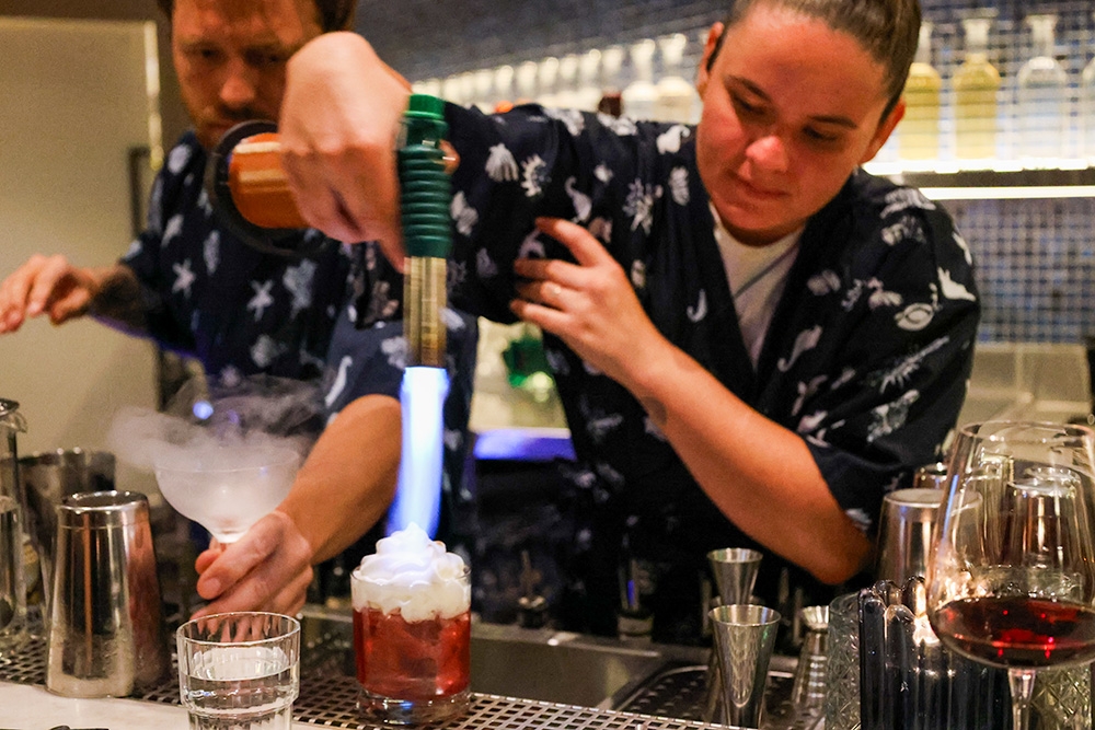 Hid Den manager making a cocktail
