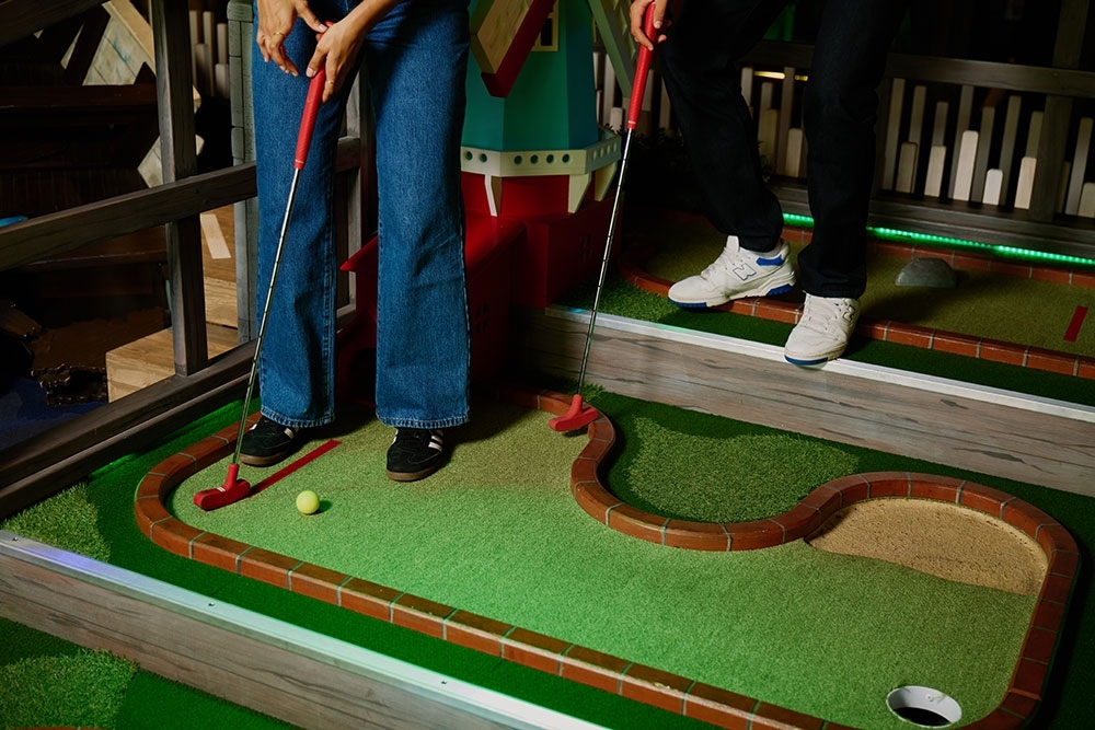 Person playing golf at Holey Moley Westfield Mt Gravatt
