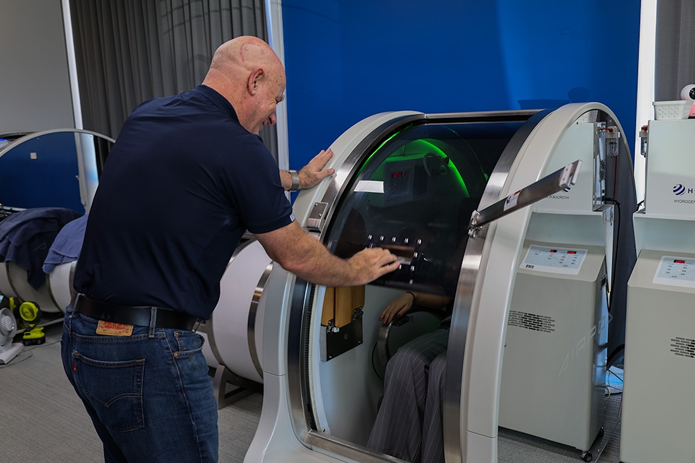 Matt helps a patient into the Hyperbaric chamber 
