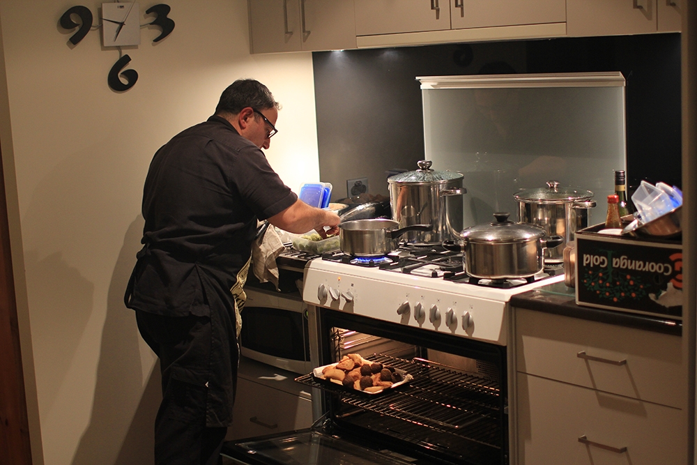Chef Robert Bousamra cooking at a stove in a kitchen 