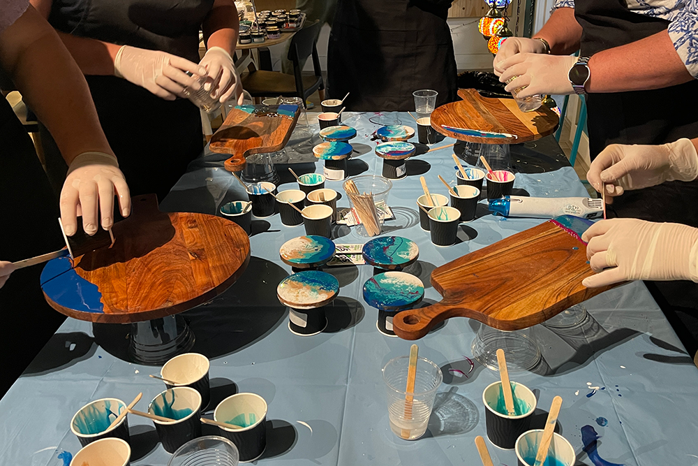A group of people at a resin art class 