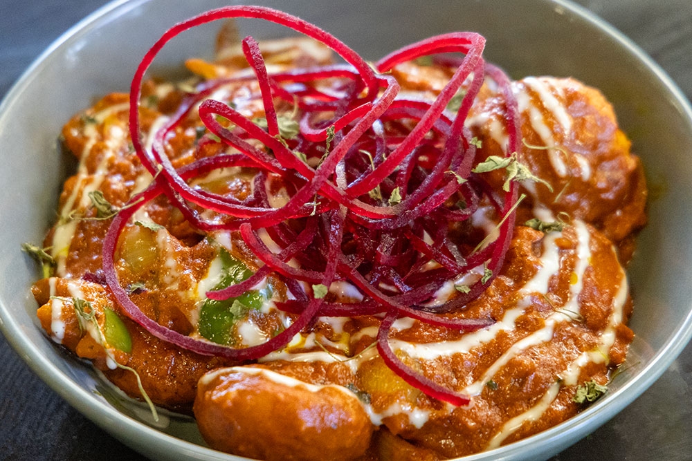 Bowl of butter chicken momos at Indian Room Milton