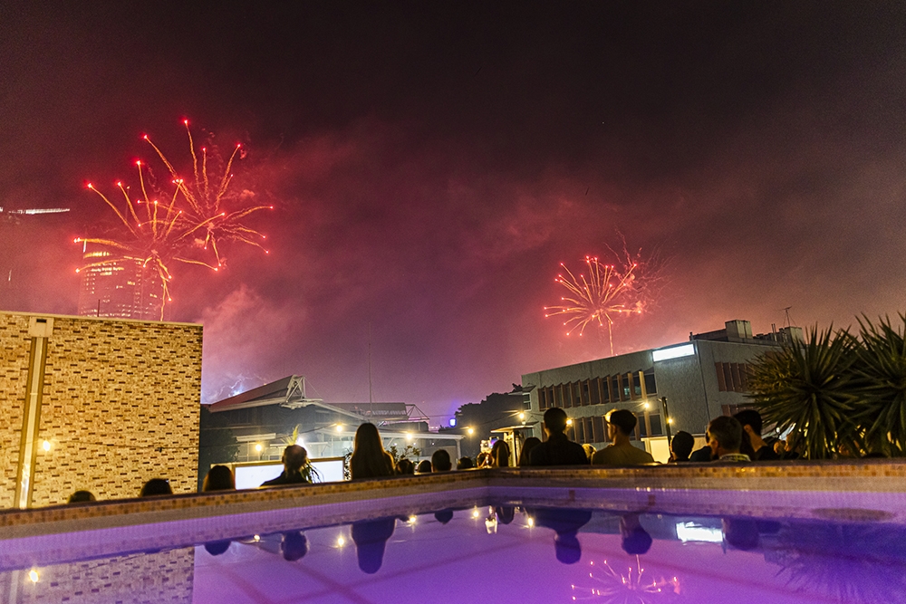 People looking at NYE fireworks on the river from Rydges Soleil Pool Bar at South Bank