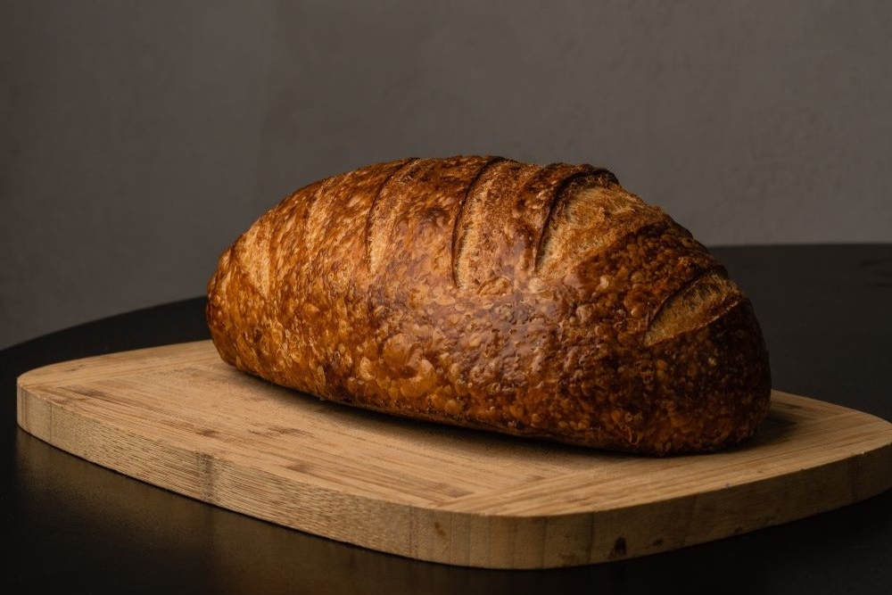 Loaf of bread on a board at James St Bakery, Fortitude Valley 