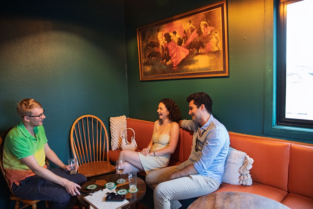 Patrons sitting on corner couches at The Junk Bar