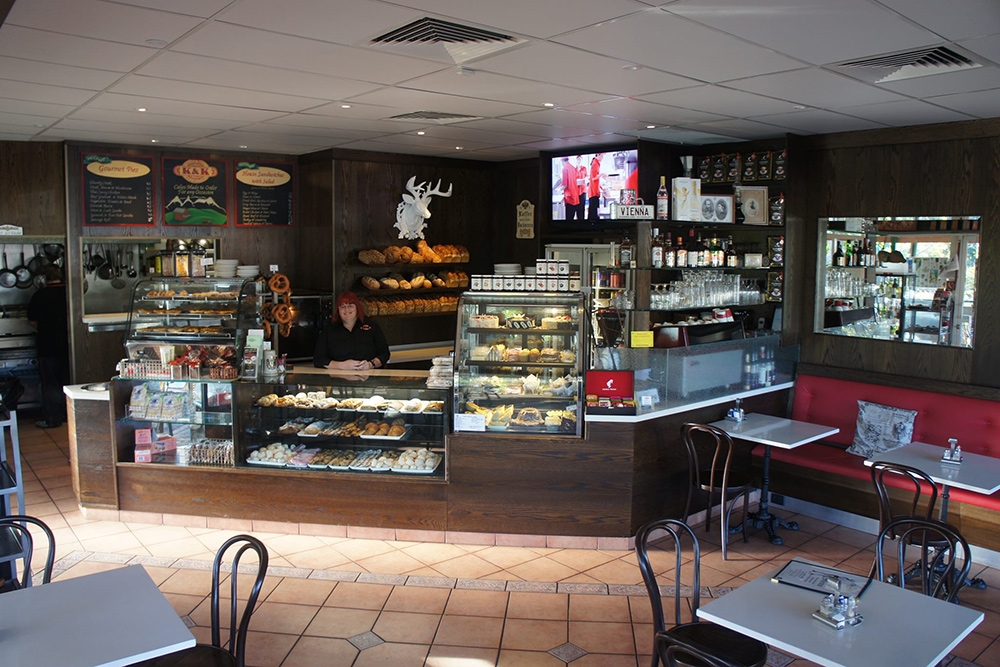 Woman behind counter at K & K Austrian Coffee House Sinnamon Park 