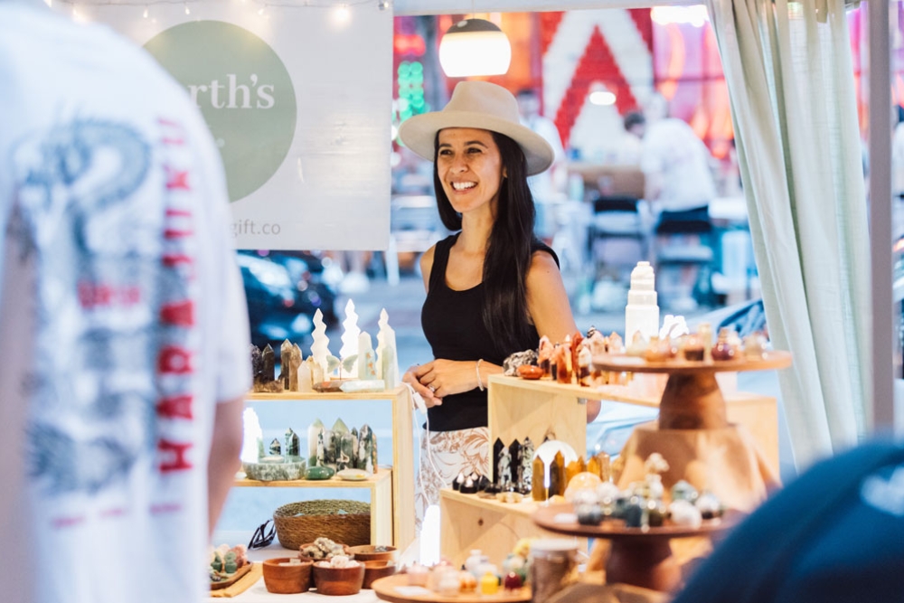 A lady at a stall at the King St Mother's Day Market