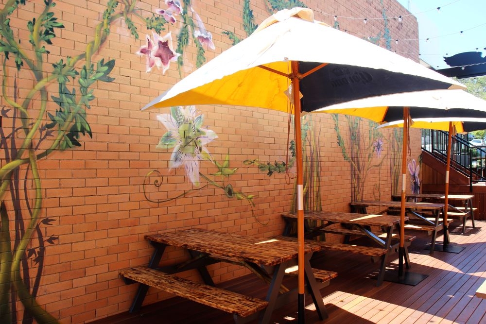 Courtyard seating with umbrellas outside King of the Wings, Stafford