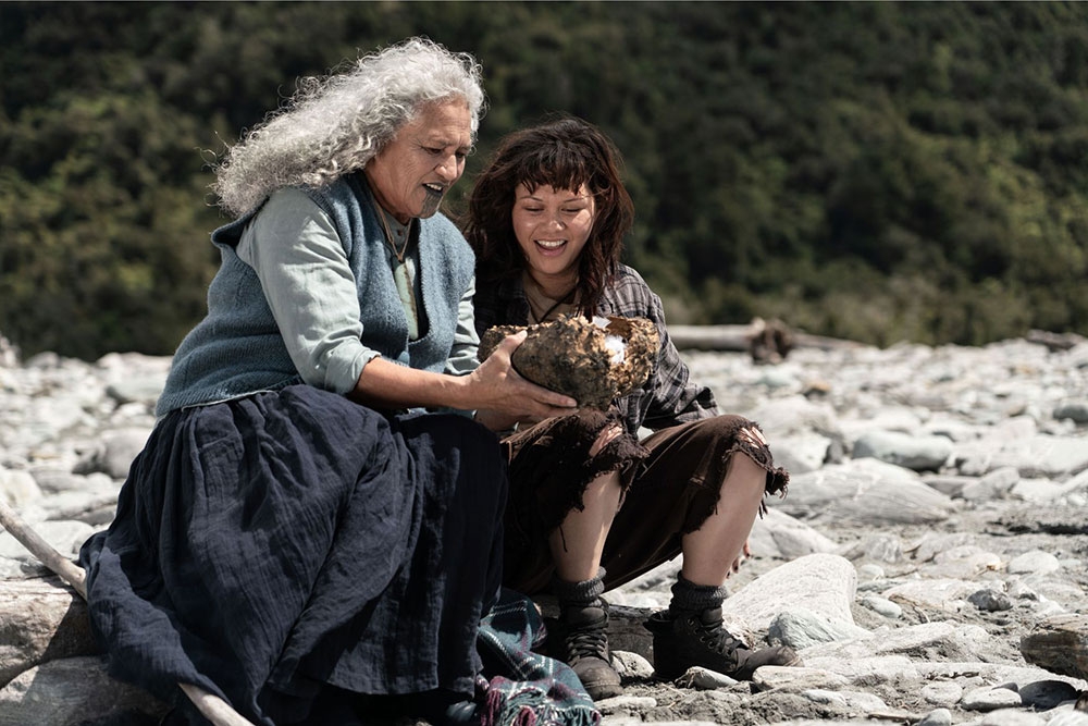 Scene of a Māori elder and you Māori woman sitting at a beach in the Kōkā movie Brisbane International Film Festival 2025